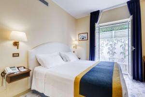 a bedroom with a large bed and a large window at Best Western Hotel La Solara in Sorrento