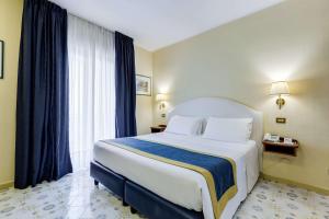 a bedroom with a large bed and a large window at Best Western Hotel La Solara in Sorrento