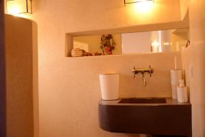 a bathroom with a sink and a mirror at DAR SOKASA Riad authentique et contemporain in Aït Skouala +7 photos
