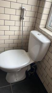 a white toilet in a bathroom with a window at The Liverpool Pod Travel Hostel in Liverpool