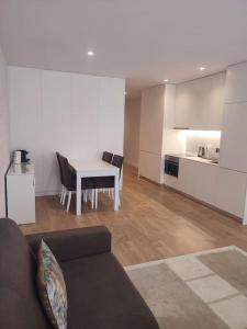 a living room with a couch and a table and a kitchen at Braga Center Apartments - São Vicente 78 in Braga