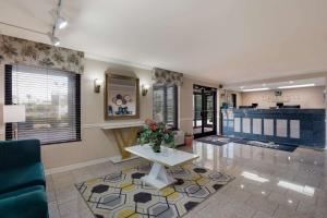 a living room with a couch and a table at Quality Inn Fort Jackson in Columbia