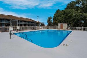 a large swimming pool with blue water at Quality Inn Fort Jackson in Columbia