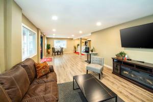 a living room with a couch and a flat screen tv at Econo Lodge Inn & Suites in Pincher Creek