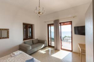 a living room with a couch and a table at Villa Grazia Lipari in Lipari