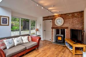 a living room with a couch and a fireplace at Finest Retreats - Heath Hills in Okehampton