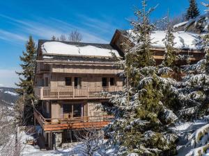 a log house in the snow with snow covered trees at Chalet calme avec terrasse, proche pistes, Méribel - FR-1-565-37 in Les Allues