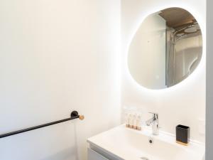 a white bathroom with a sink and a mirror at Appartement Courchevel, 3 pièces, 5 personnes - FR-1-568-30 in Courchevel