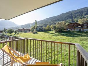 a balcony with chairs and a view of a field at Appartement Courchevel, 3 pièces, 5 personnes - FR-1-568-30 in Courchevel