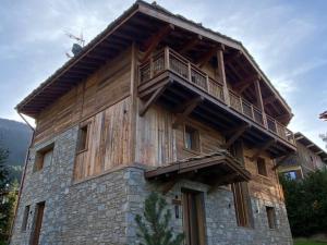 a large wooden building with a balcony on it at Chalet Courchevel, 6 pièces, 10 personnes - FR-1-568-33 in Courchevel