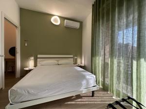 a bedroom with a bed and a large window at Meridian A23 in Reggio Emilia