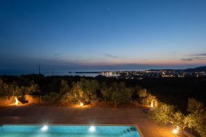 a villa with a swimming pool at night at Modone Villas in Peloponnese in Methoni