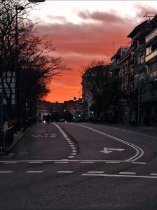 an empty street with a sunset in the background at Madera de Olmo in Madrid