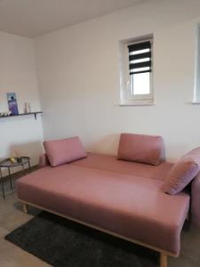 ein Sofa in einem Zimmer mit Fenster in der Unterkunft Lauda i bric in Mirna