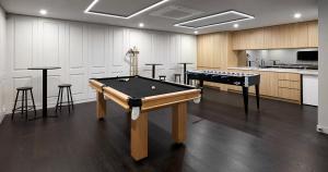 a room with two pool tables and bar stools at Luxury Living, Richmond in Melbourne