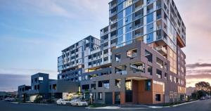 a rendering of a tall building with cars parked in front at Luxury Living, Richmond in Melbourne