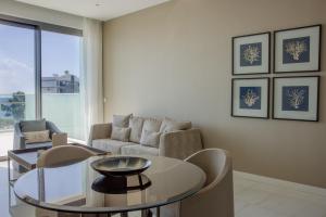 a living room with a table and a couch at Limassol Del Mar in Limassol