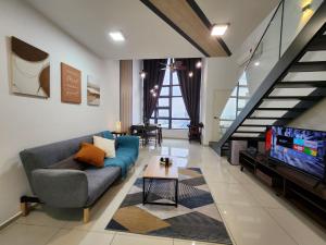 a living room with a couch and a tv at EkoCheras Duplex Suite by Ohana Home in Kuala Lumpur