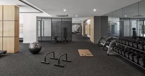 a gym with a bunch of chairs and weights at Luxury Living, Richmond in Melbourne