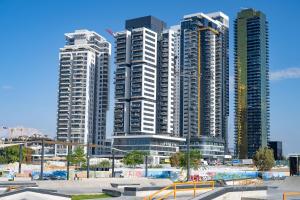 a group of tall buildings in a city at Hi-Yam SeaView Apartments & Suites - יש ממ"ד in Bat Yam