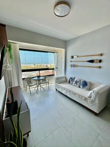 sala de estar con sofá y mesa en Apartamento vista mar Atalaia todos quartos climatizados en Aracajú