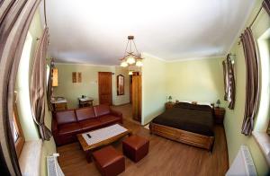 a living room with a bed and a couch at Chata Sudecka in Sienna