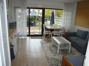 a living room with a couch and a table at Tac Home 2-Zimmer Wohnung in Sindelfingen