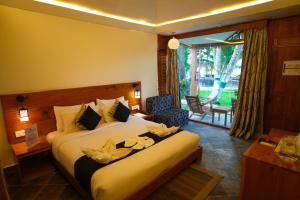 a hotel room with a bed with flowers on it at Havelock Island Beach Resort in Havelock Island