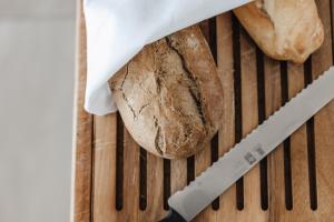 a loaf of bread and a knife on a table at Limassol Del Mar in Limassol