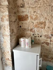 a counter with three rolls of toilet paper on it at Trullo Sofia in Monopoli
