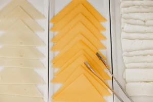a wall with yellow paper and a christmas tree at Limassol Del Mar in Limassol