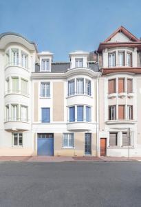 a large white building on the corner of a street at Le Louis B - Appartement calme et lumineux proche Thermes in Vichy