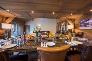 a dining room with a large wooden table and chairs at Chalet Ambre in Tignes