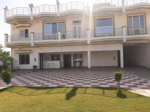 a large house with a checkered floor at Hotel Vaidehi in Varanasi