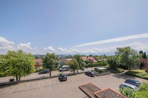 a parking lot with cars parked in a parking lot at Ferienwohnpark Immenstaad am Bodensee Ein-Zimmer-Apartment 49 41 in Immenstaad am Bodensee