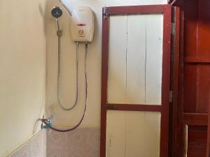 a shower in a bathroom with a shower head on the wall at Souksanh Guesthouse in Ban Donsôm