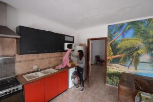 a woman is in a kitchen with at Hostel Aeropuerto Ezeiza in Monte Grande