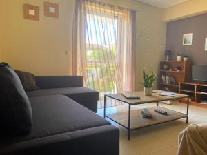 a living room with a couch and a coffee table at Xrysa's Garden in Missolonghi