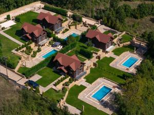 an aerial view of a house with two swimming pools at Evritos Villas & Suites with pool in Karpenisi