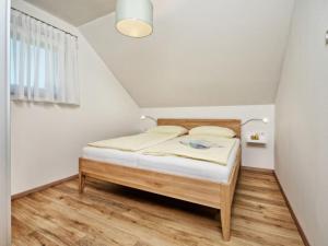 a small bedroom with a bed in a attic at Apartment Elisabeth by Interhome in Egg am Faaker See