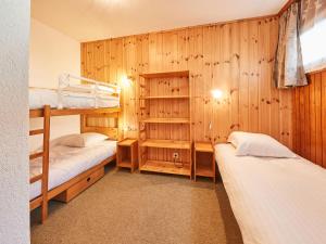 2 Etagenbetten in einem Zimmer mit Holzwänden in der Unterkunft Apartment Greppon 306 by Interhome in Les Collons