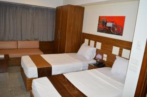 Postel nebo postele na pokoji v ubytování Royal Inn Residence