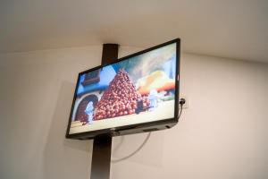 a flat screen tv hanging on a wall at Pondok Tingal Borobudur in Magelang