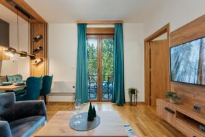 a living room with a couch and a table at Apartman Zelenbor 4 Vila Zlatibor Luxury&Spa in Zlatibor