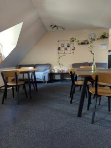 a living room with two tables and a couch at Hostel John Galt in Brno
