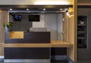 an office with a desk with a chair in it at B&B HOTEL La Rochelle Angoulins in Angoulins-sur-Mer