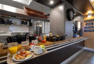 a kitchen with a plate of food on a counter at B&B HOTEL La Rochelle Angoulins in Angoulins-sur-Mer