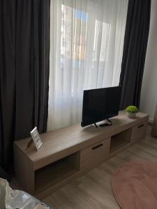 a flat screen tv sitting on a table in a room at Luana & Priam home in Petrila