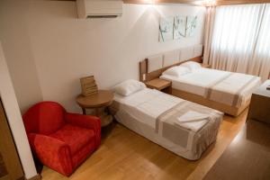 a hotel room with two beds and a red chair at Bitez Corner Boutique Hotel in Bitez +66 photos