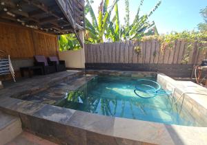 a swimming pool in the middle of a backyard at Chez les Rakoto in Koungou